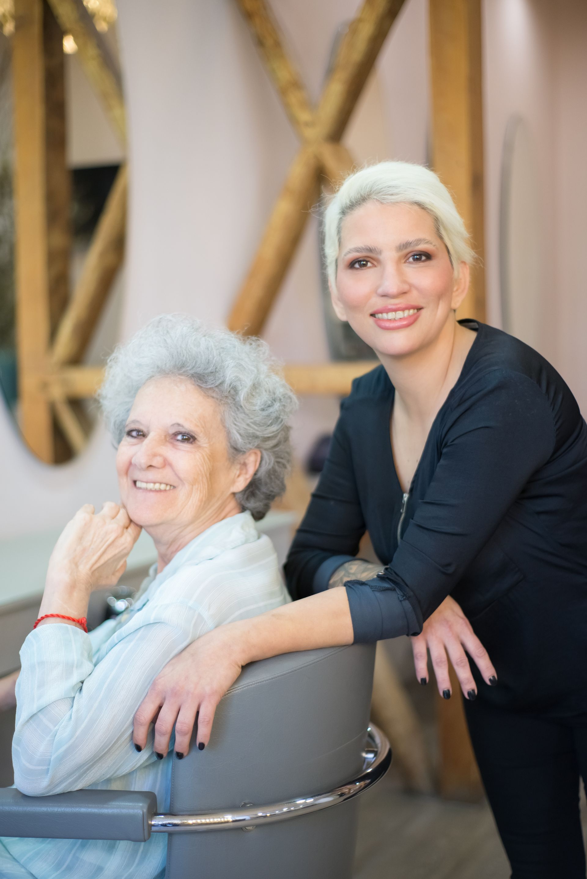 Two women smiling together in a beauty salon